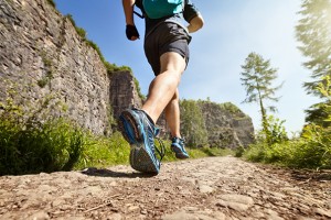 Outdoor cross-country running in summer sunshine concept for exercising, fitness and healthy lifestyle